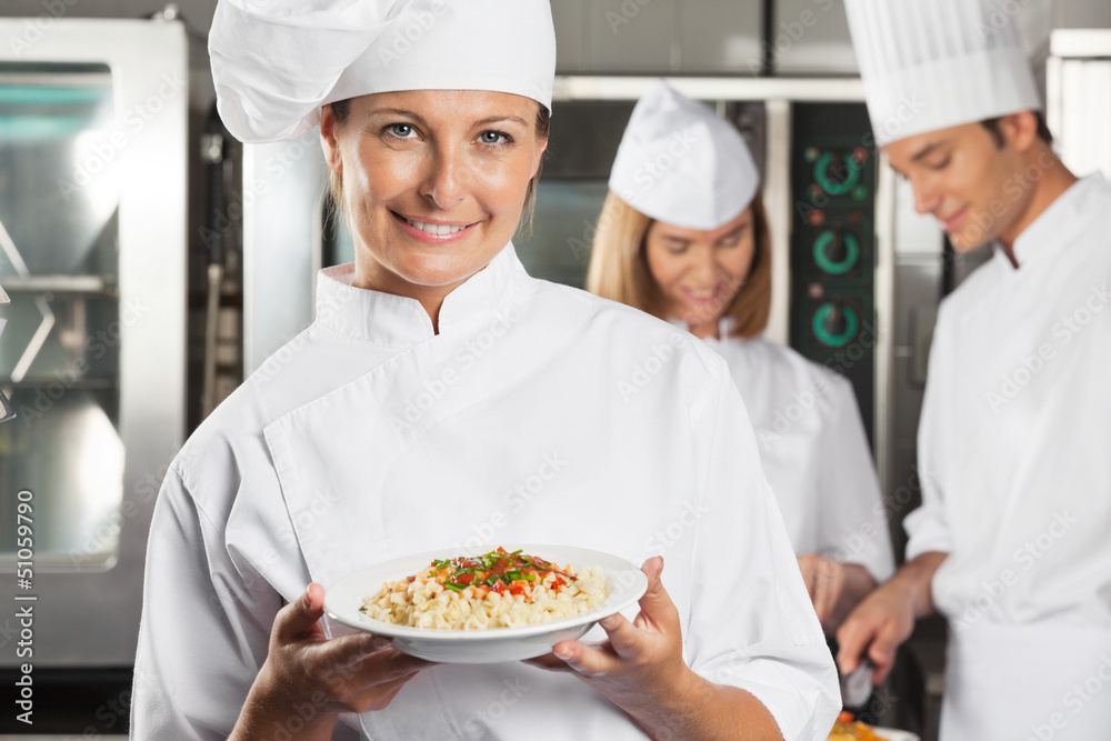 Happy Female Chef Presenting Dish Happy Female Chef Presenting Dish