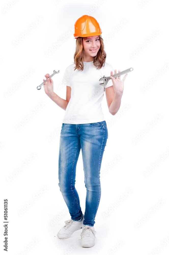 beautiful girl in a building helmet and tools in hand beautiful girl in a building helmet and tools in hand