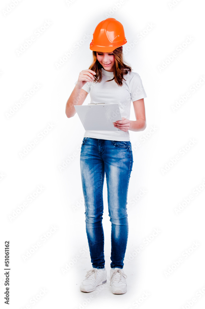 beautiful girl in a building helmet and tools in hand beautiful girl in a building helmet and tools in hand