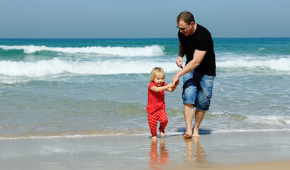 father and daughter on the beach