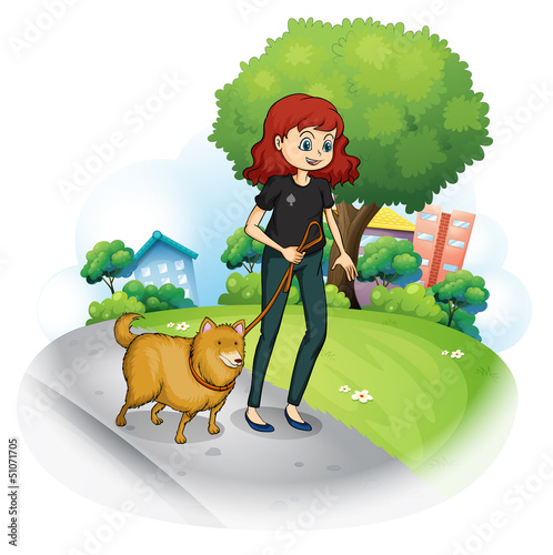 A girl with a dog walking along the street