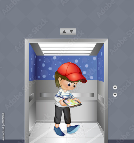 A boy with a tablet inside the elevator