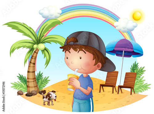 A young boy at the beach with his pet