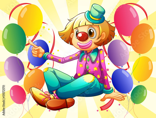 A female clown sitting in the middle of the balloons