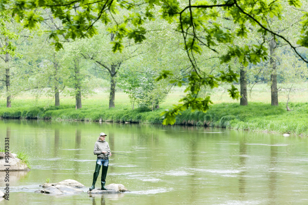 woman fishing in Sazava river, Czech Republic woman fishing in Sazava river, Czech Republic