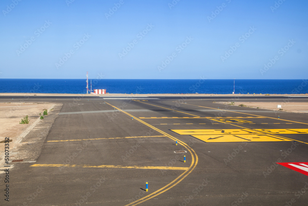 runway with ocean in the background