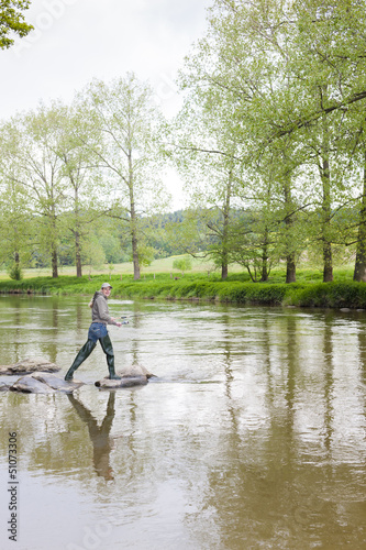 woman fishing in Sazava river, Czech Republic