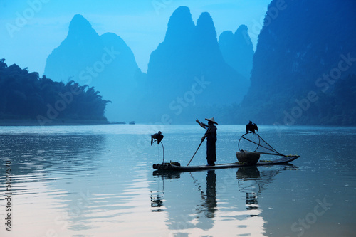 Chinese man fishing with cormorants birds, Yangshuo, Guangxi reg