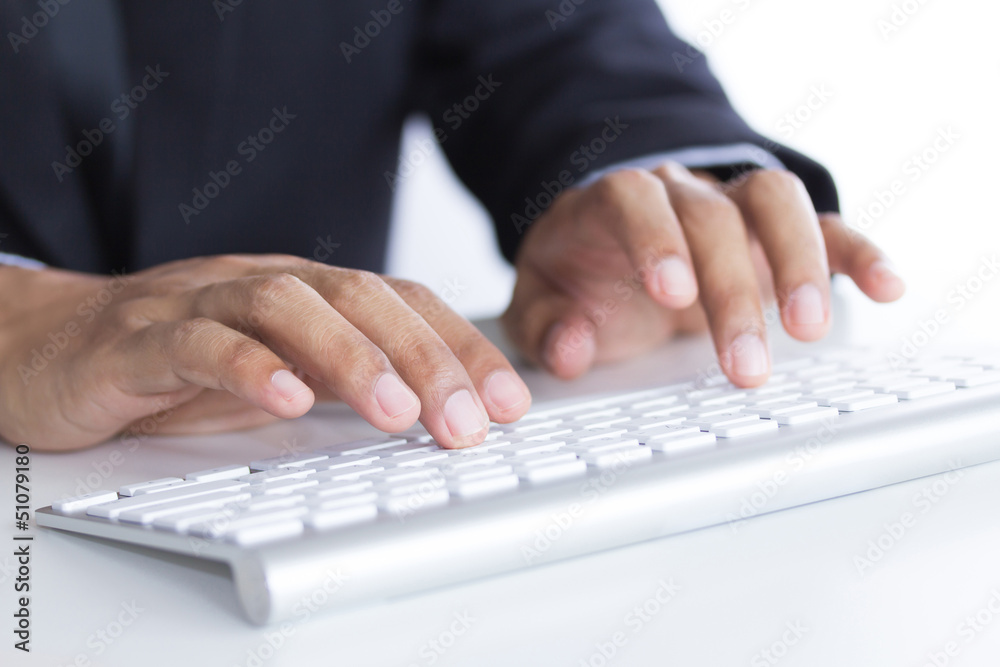 Business hands typing on keyboard in office Business hands typing on keyboard in office