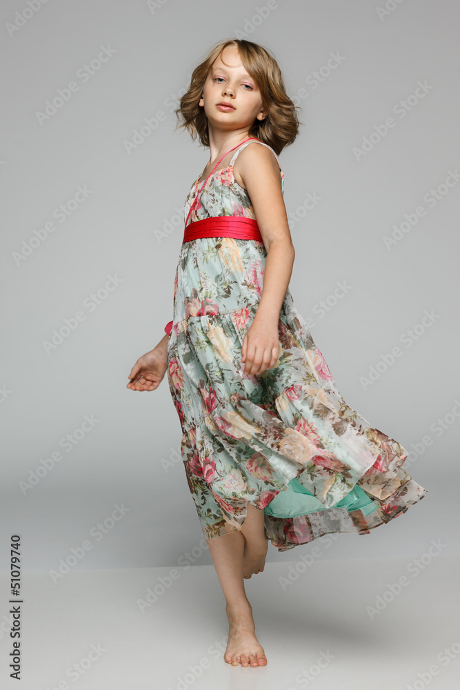 Little girl dancing in studio wearing light chiffon dress Little girl dancing in studio wearing light chiffon dress