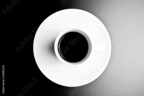 black and white symmetry, top view of cup of black coffee
