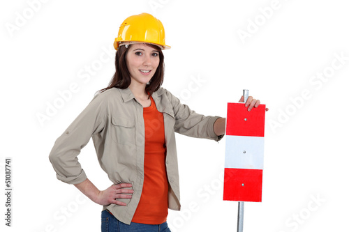 Brunette stood with warning sign photo