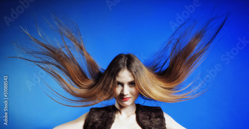 Fashion model with hair blowing in the wind
