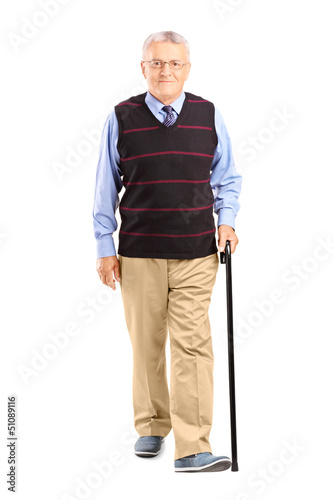 Full length portrait of a senior man walking with a cane © Ljupco Smokovski