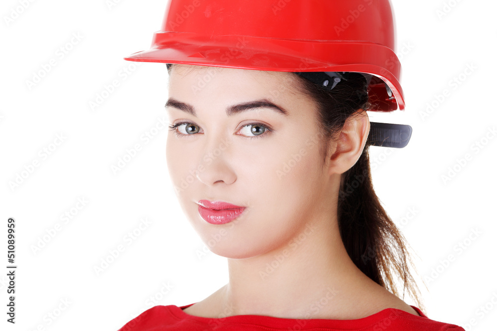 Portrait of confident female worker in helmet.