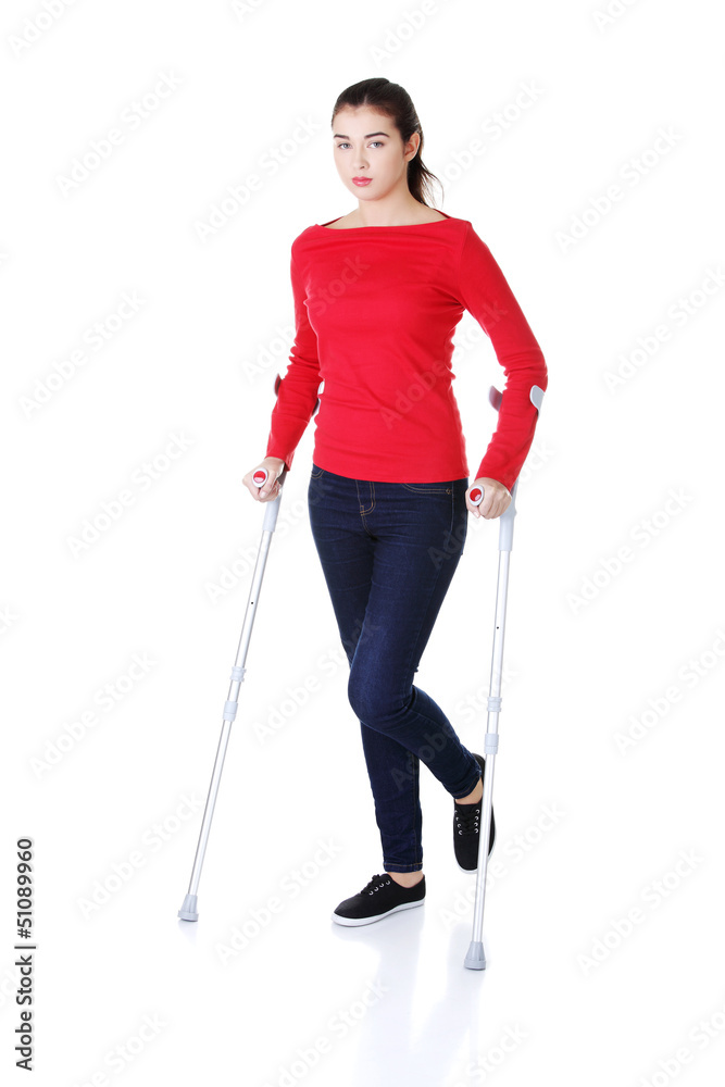 Woman walking with crutches Woman walking with crutches