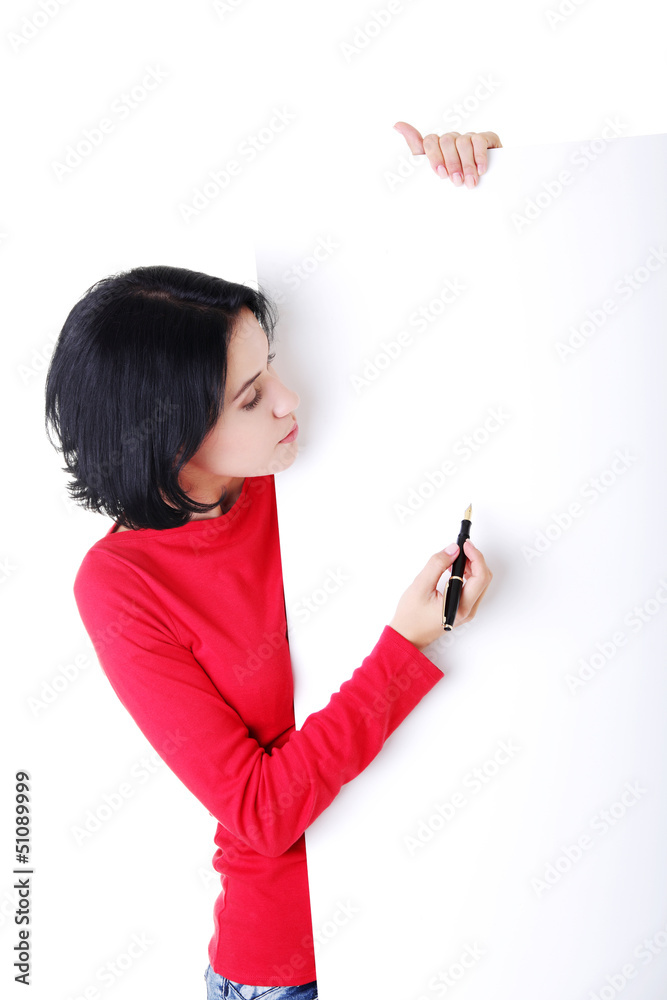 Happy woman writing with a pen on blank board Happy woman writing with a pen on blank board