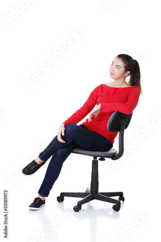 Young happy woman sitting on a wheel chair