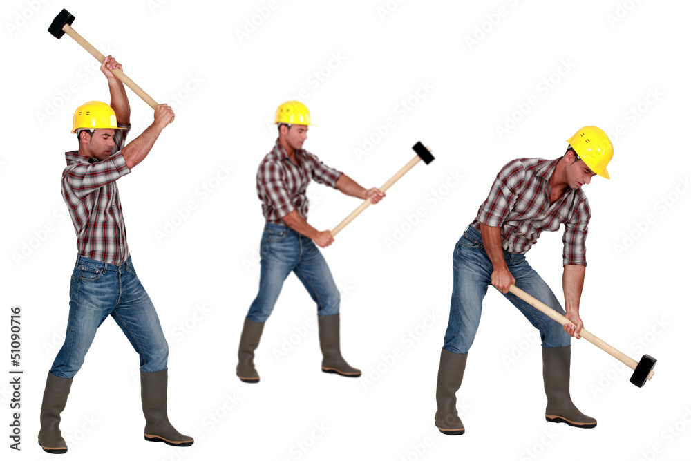 Tradesman laboriously using a mallet Tradesman laboriously using a mallet