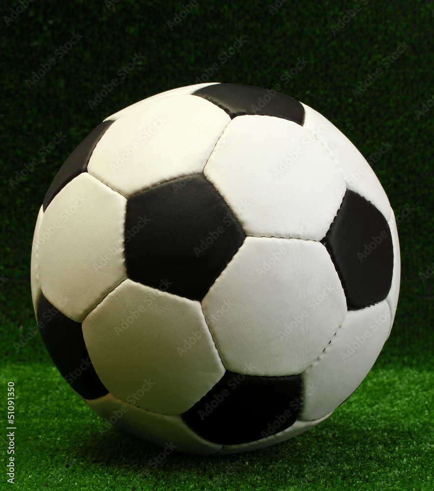 football ball on artificial green grass