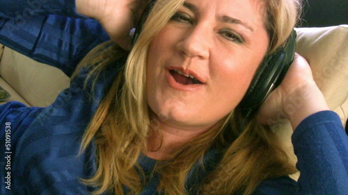 Woman listening to music with headphones photo