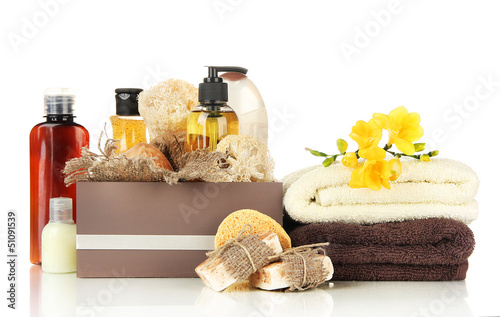 Composition of cosmetic bottles and soap in crate, isolated