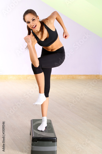 Young woman doing fitness e...