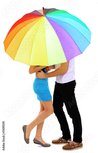 Loving couple standing with umbrella isolated on white