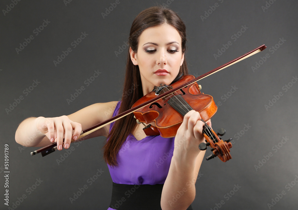 Beautiful young girl with violin on grey background Beautiful young girl with violin on grey background