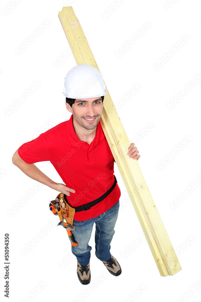 high angle shot portrait of craftsman carrying lumber high angle shot portrait of craftsman carrying lumber