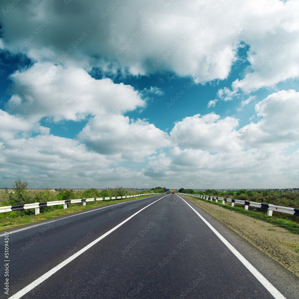 asphalt road under dark cloudy sky asphalt road under dark cloudy sky