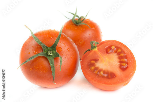 Tomatoes with green leaves isolated on white background