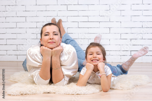 Mom with 5 year old daughter lying on the floor