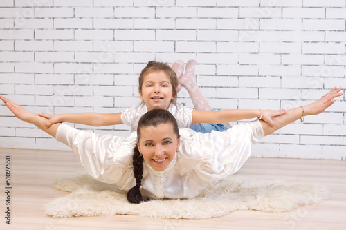 daughter riding on her mother portrayed flying