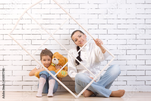 Mother and 5 year old daughter , holding a toy