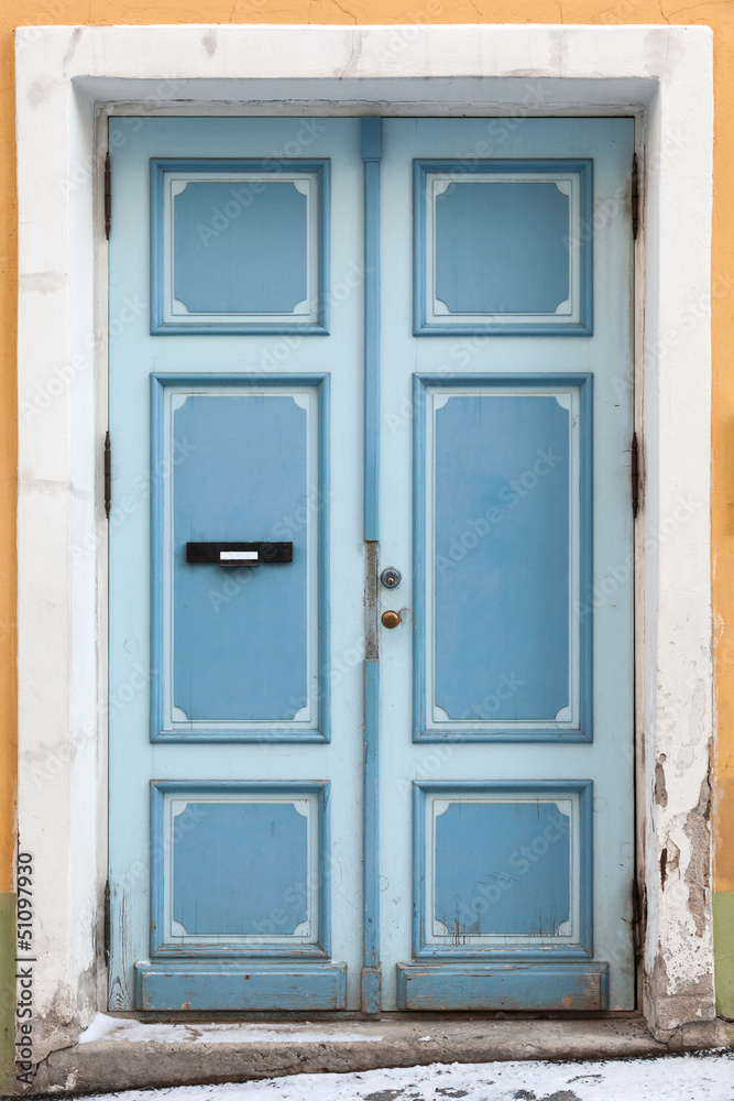 Blue wooden door in old building facade. Tallinn, Estonia