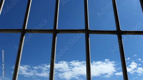 Prison bars and blue sky, dolly