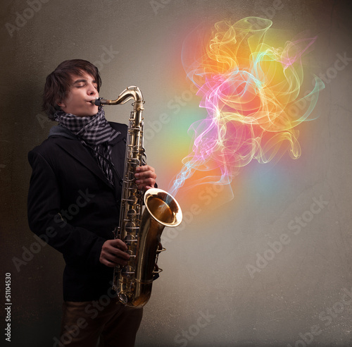 Attractive musician playing on saxophone with colorful abstract