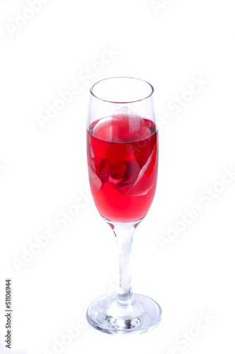 glass with red wine and an orchid