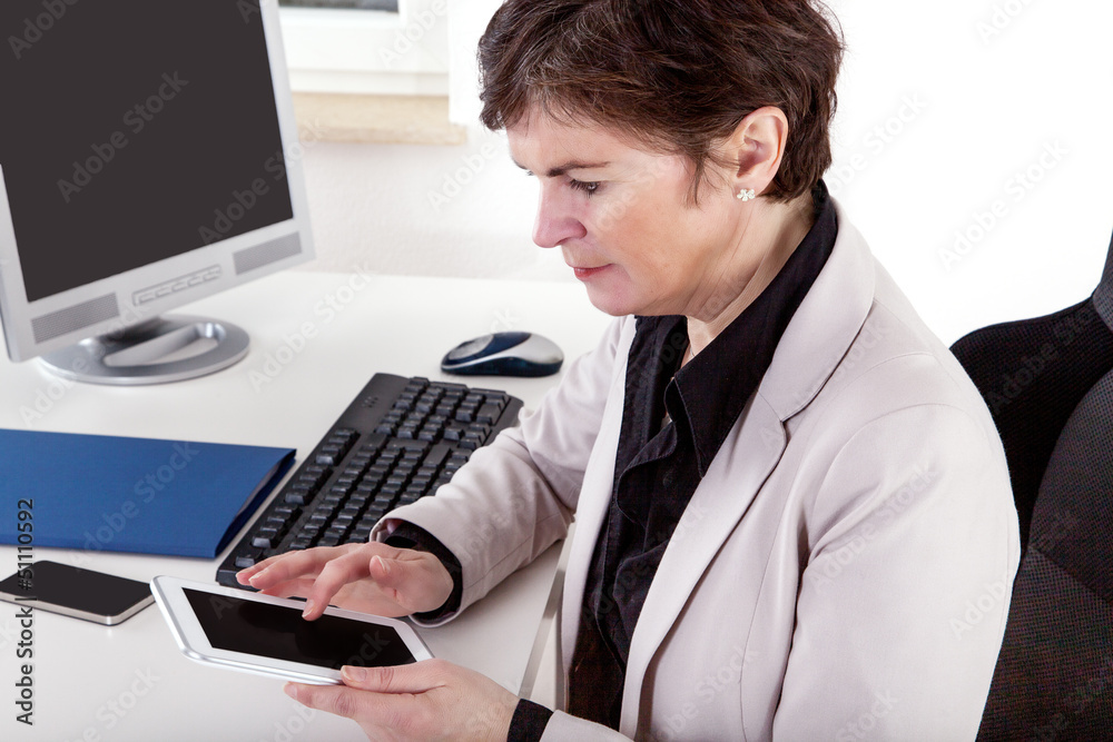 Businesswoman in office with tablet PC Businesswoman in office with tablet PC