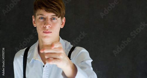 Photo Your country needs you pointing man on blackboard background