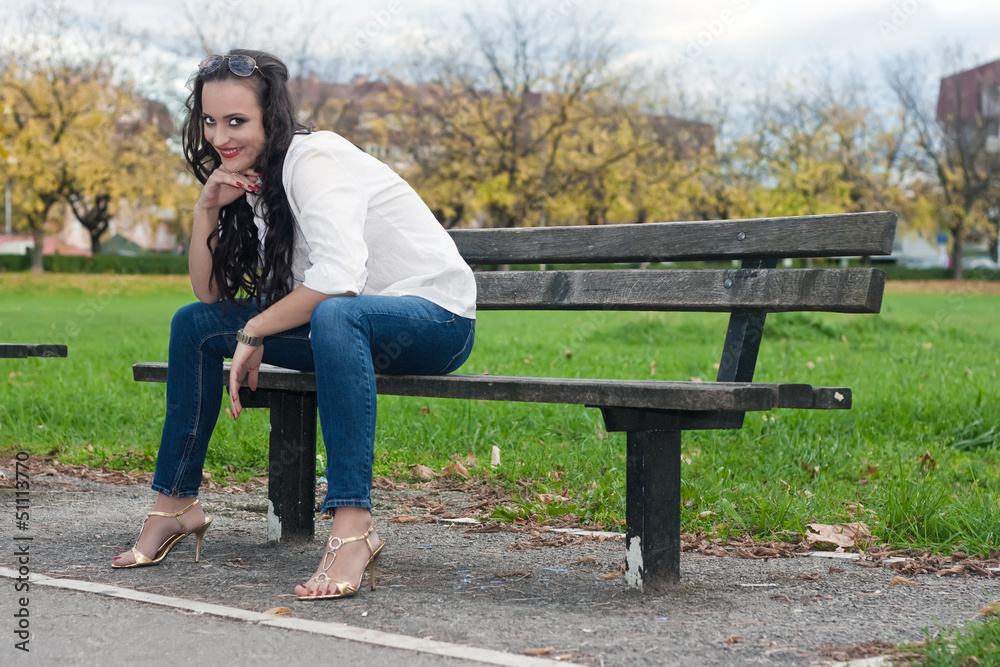 Young woman sitting on the bench Young woman sitting on the bench