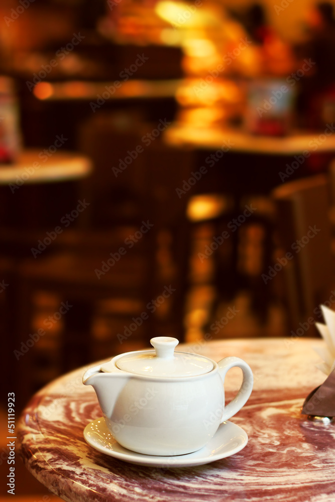 Image of teapot on a table in cafe