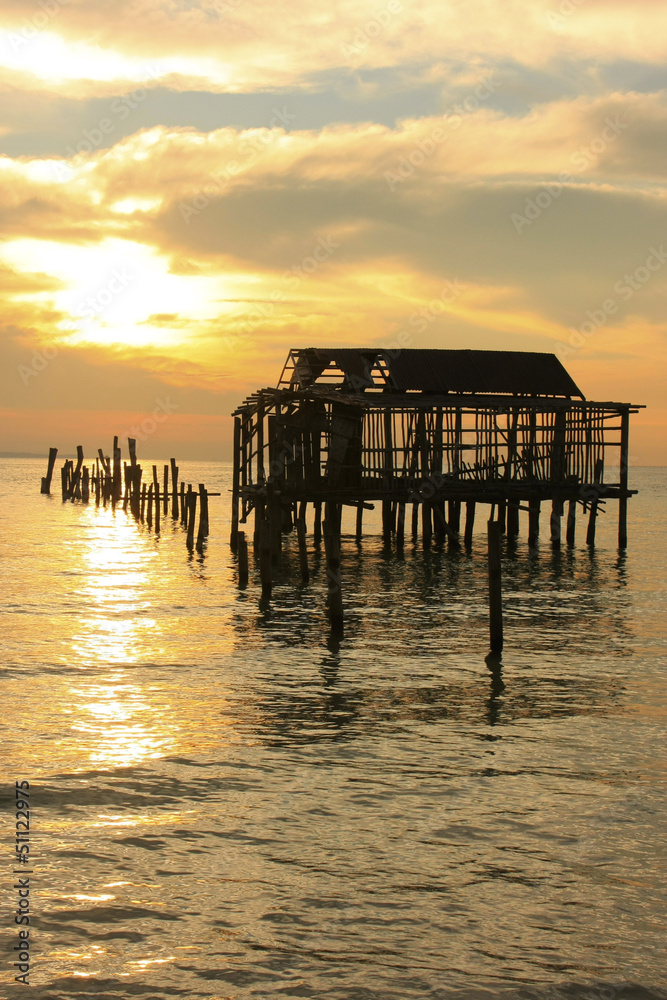 Silhouette of old wooden jetty at sunrise, Koh Rong island, Camb