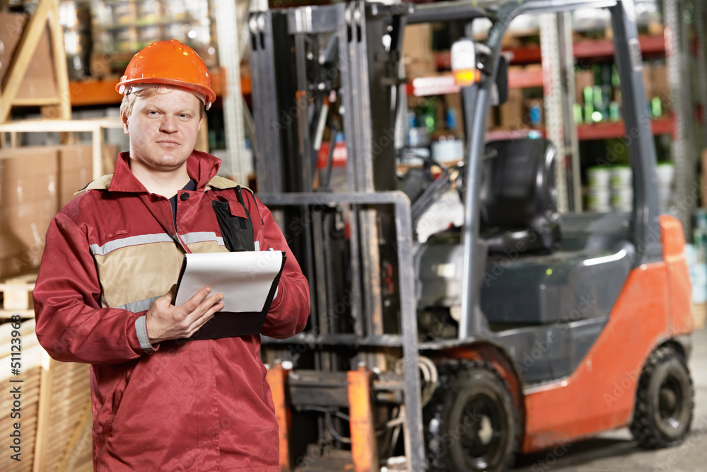 warehouse worker in front of forklift warehouse worker in front of forklift