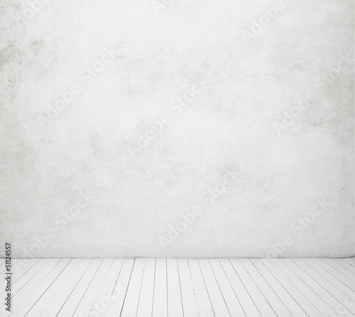 white concrete wall and wood floor