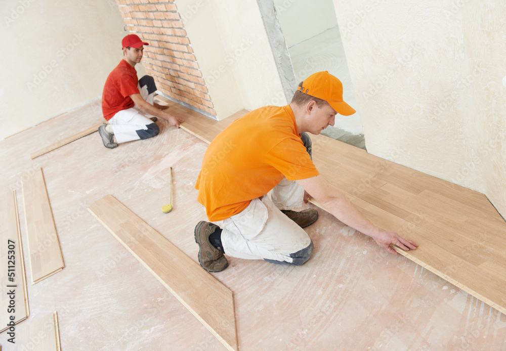 parquet workers at flooring work - obrazy, fototapety, plakaty 