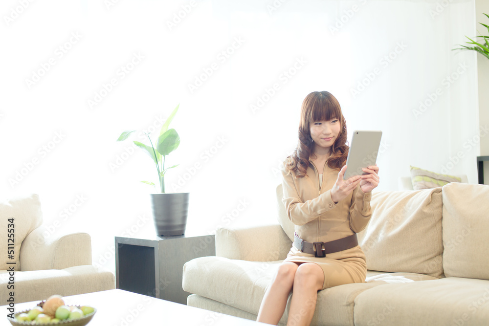 Beautiful asian woman using a tablet computer Beautiful asian woman using a tablet computer