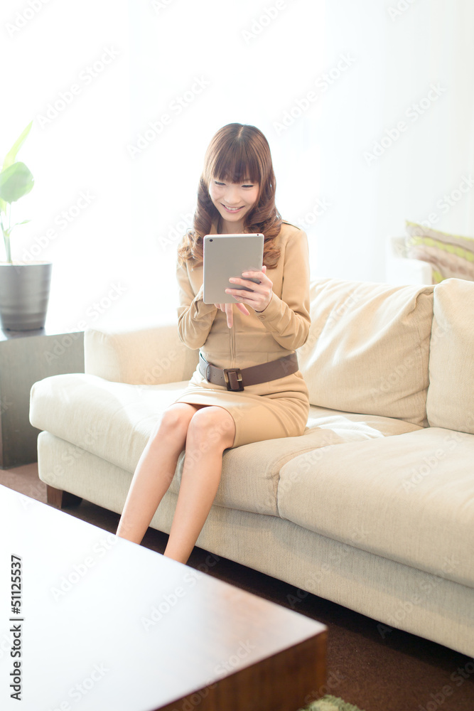 Beautiful asian woman using a tablet computer Beautiful asian woman using a tablet computer
