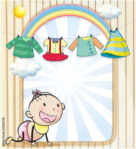 A baby girl with hanging clothes